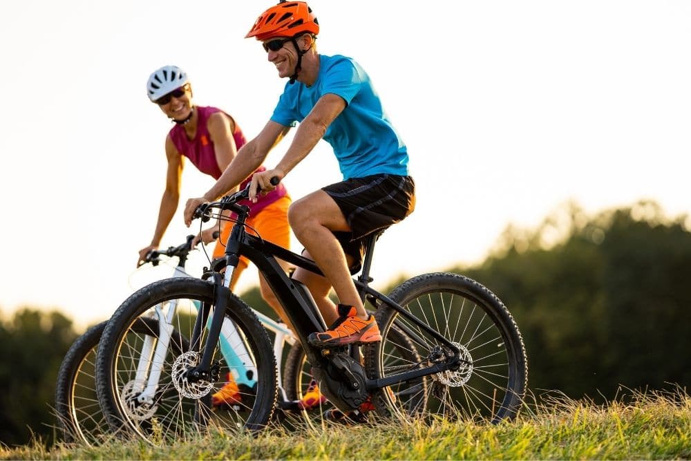 Couple on electric mountain bikes