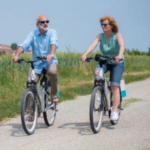 Couple on ebikes on countryside road