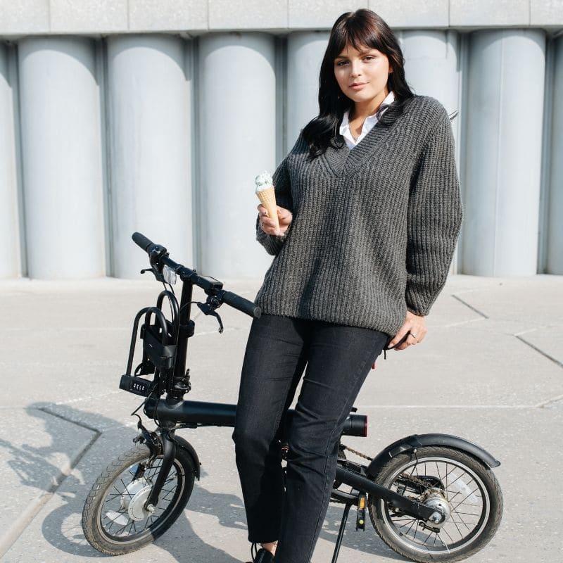 Girl next to her folding electric bike