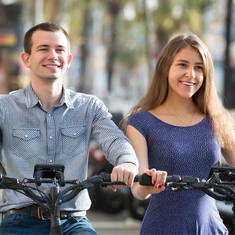 Young couple enjoying time on ebikes