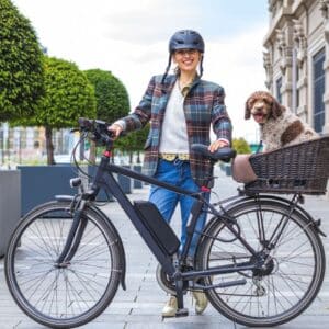 Girl with ebike and dog in basket